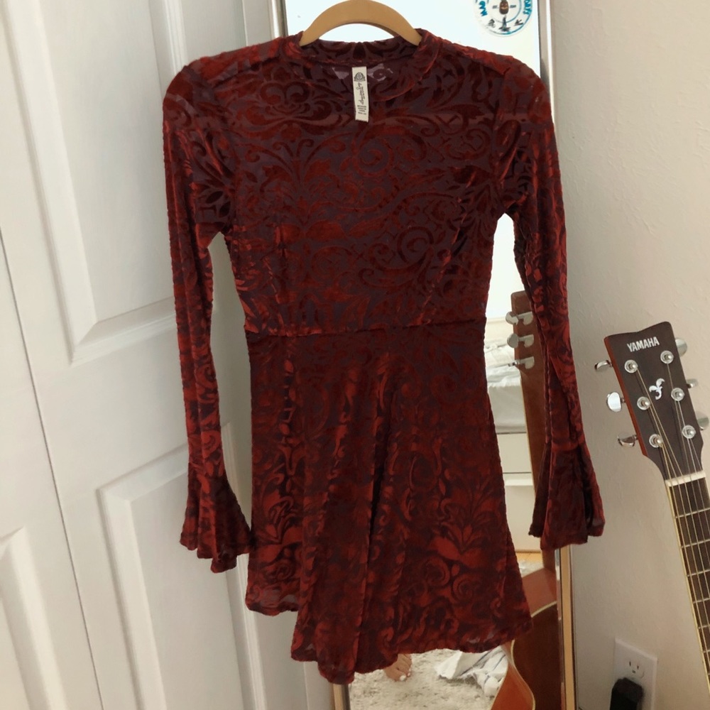 Red floral velvet dress with bell sleeves.